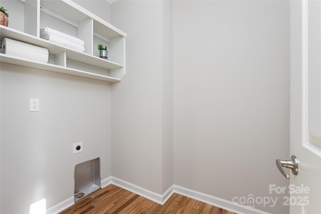 laundry room with baseboards, laundry area, wood finished floors, and hookup for an electric dryer