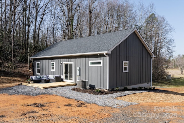 exterior space with an outdoor structure, an outdoor living space, roof with shingles, crawl space, and board and batten siding