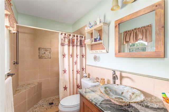 bathroom featuring tiled shower, vanity, and toilet