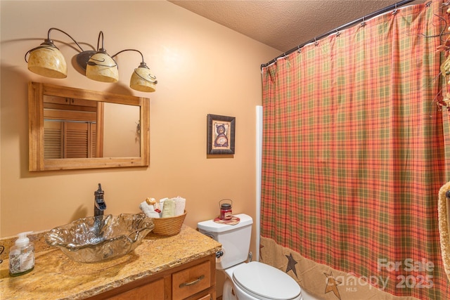 bathroom featuring a textured ceiling, curtained shower, toilet, and vanity