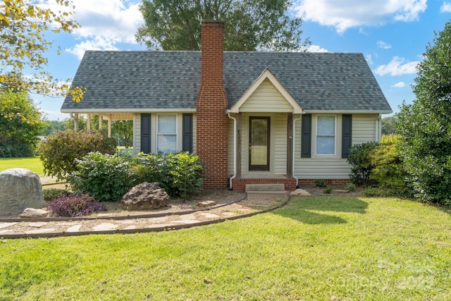 view of front of house featuring a front yard, crawl space, roof with shingles, and a chimney