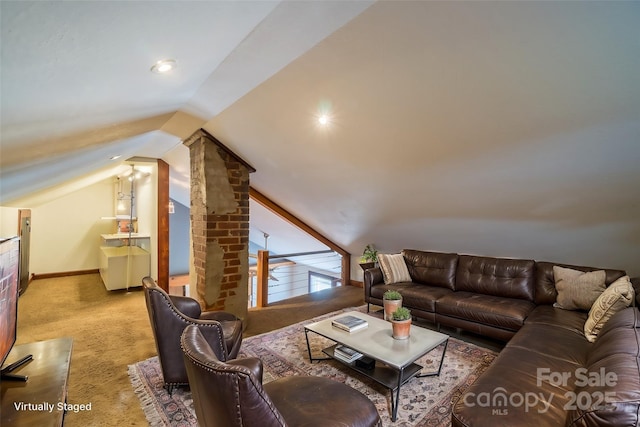 living room with carpet, baseboards, and vaulted ceiling