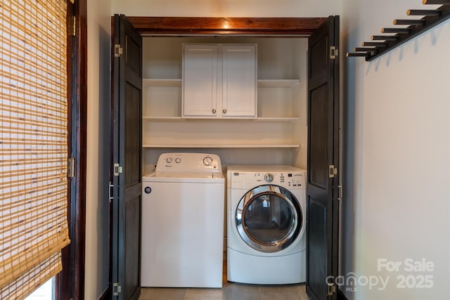 washroom with cabinet space and washing machine and clothes dryer