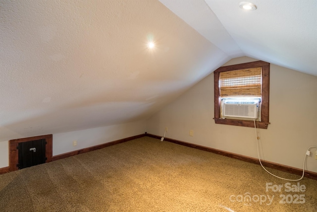 additional living space featuring lofted ceiling, carpet floors, cooling unit, and baseboards