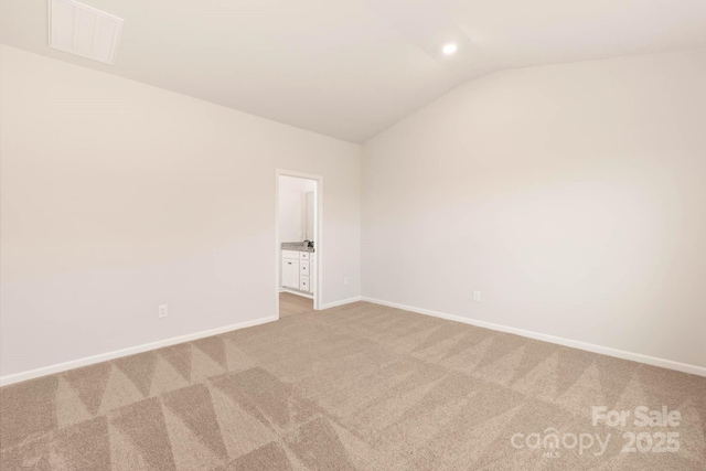 unfurnished room featuring baseboards, visible vents, light colored carpet, vaulted ceiling, and recessed lighting