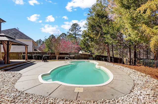 view of pool featuring a gazebo, a patio area, a fenced backyard, and a fenced in pool