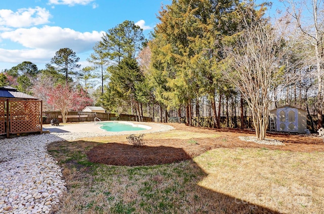 view of yard featuring a patio, a fenced backyard, a storage shed, an outdoor structure, and a gazebo