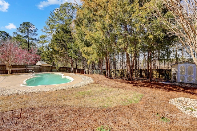 view of pool featuring a fenced in pool, an outbuilding, a fenced backyard, and a storage shed