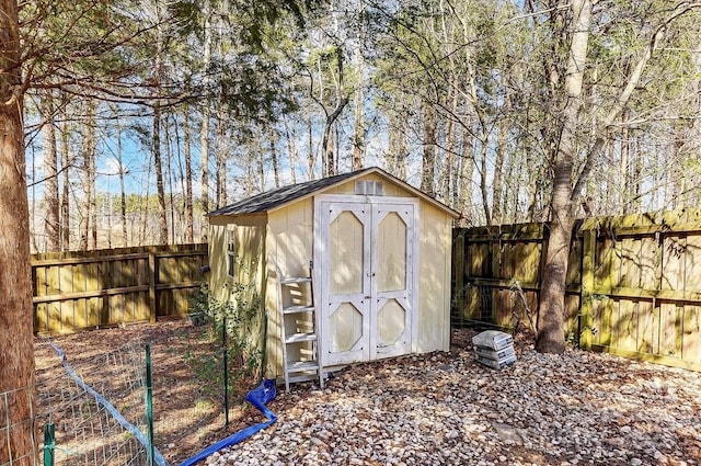 view of shed with a fenced backyard