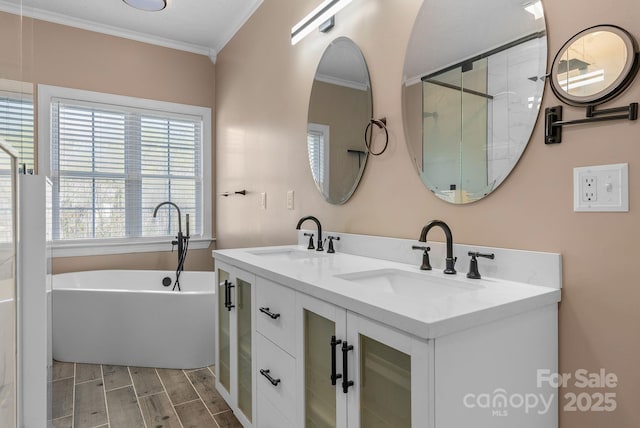 79 Mill Pond Way, Hendersonville, NC 28791 - full bathroom featuring wood finish floors, a freestanding tub, a sink, and ornamental molding