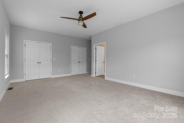79 Mill Pond Way, Hendersonville, NC 28791 - unfurnished bedroom featuring baseboards, multiple closets, visible vents, and carpet