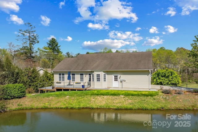 79 Mill Pond Way, Hendersonville, NC 28791 - rear view of house featuring a deck with water view and a lawn