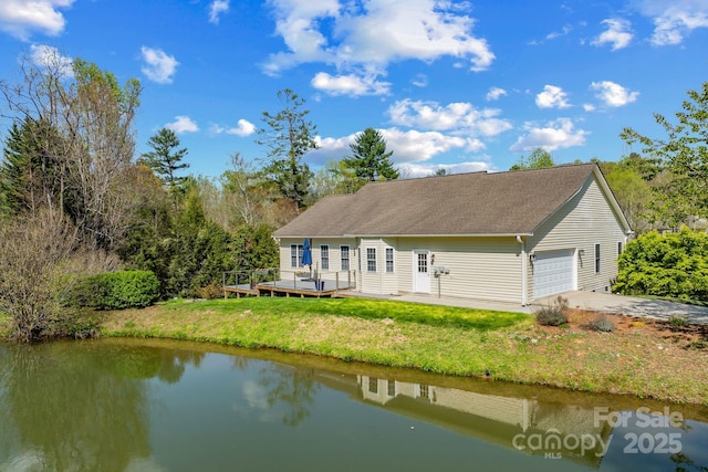 79 Mill Pond Way, Hendersonville, NC 28791 - rear view of property with a deck with water view and a lawn