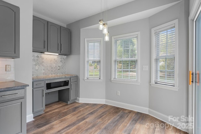 79 Mill Pond Way, Hendersonville, NC 28791 - kitchen with gray cabinetry, dark wood-style flooring, tasteful backsplash, light stone counters, and decorative light fixtures