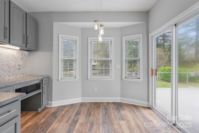 79 Mill Pond Way, Hendersonville, NC 28791 - kitchen featuring gray cabinetry, wood finished floors, backsplash, and pendant lighting