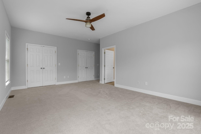 79 Mill Pond Way, Hendersonville, NC 28791 - unfurnished bedroom with two closets, carpet, and a ceiling fan