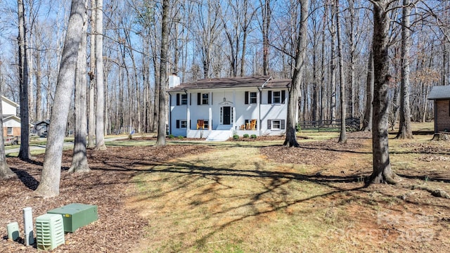 view of front of home featuring a front lawn and a chimney