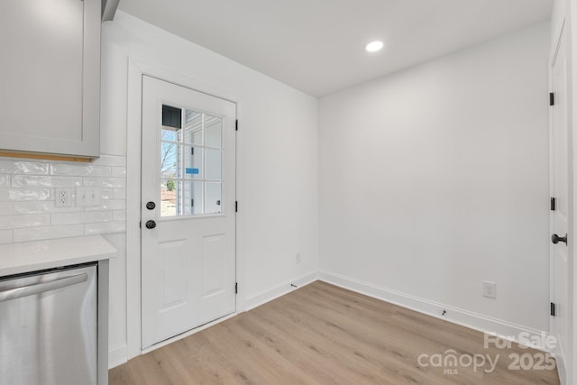 doorway to outside featuring light wood finished floors, recessed lighting, and baseboards