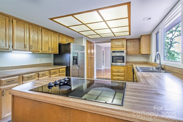 162 Southerland Rd, Pisgah Forest, NC 28768 - kitchen featuring stainless steel appliances, a sink, light countertops, and brown cabinets