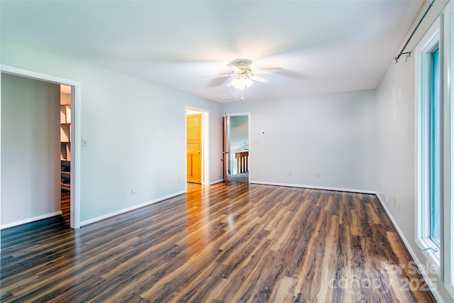 162 Southerland Rd, Pisgah Forest, NC 28768 - unfurnished bedroom featuring dark wood-style floors, baseboards, and ceiling fan