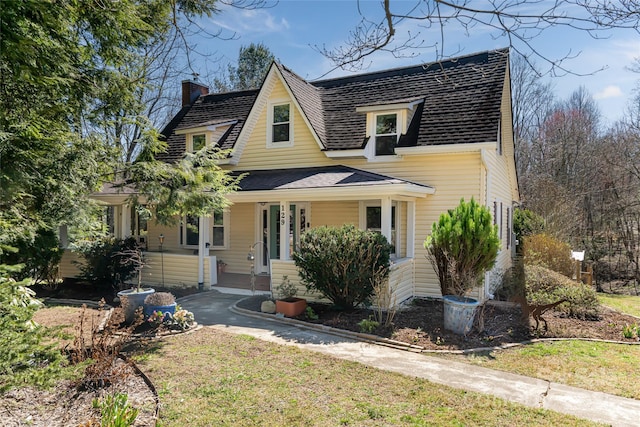 view of front of home with a porch and a shingled roof