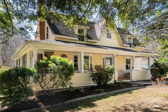 view of front of property with covered porch and a chimney