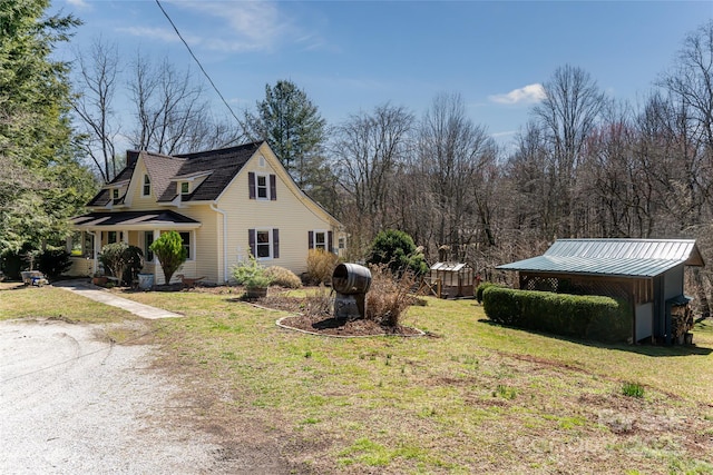 view of property exterior with a standing seam roof, metal roof, and a yard