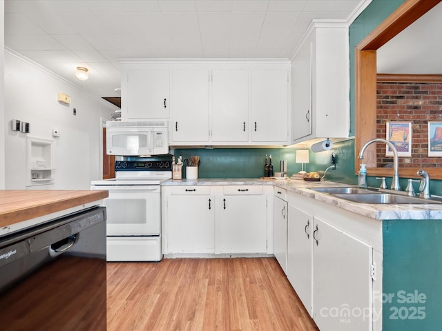 kitchen with ornamental molding, white cabinets, a sink, light wood-type flooring, and white appliances