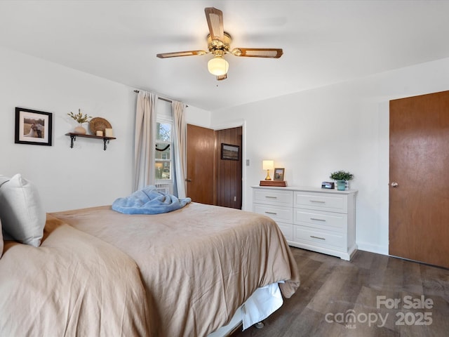 bedroom with dark wood-type flooring and a ceiling fan