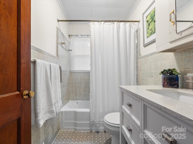 full bathroom with toilet, crown molding, tile walls, and shower / tub combo with curtain