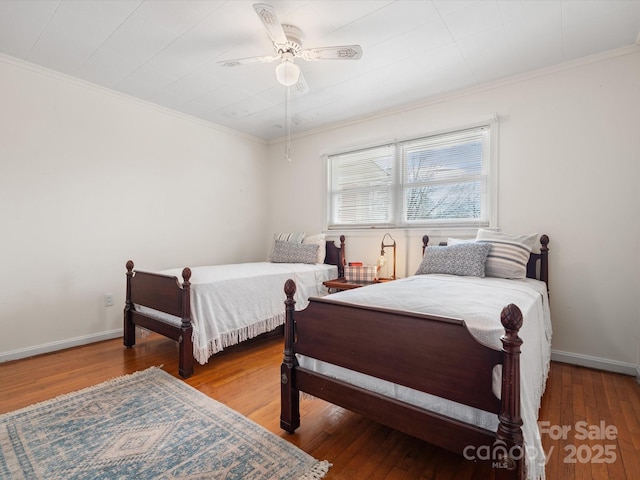 bedroom with wood-type flooring, baseboards, and ornamental molding