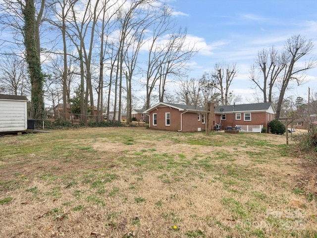 view of yard featuring fence and an outdoor structure