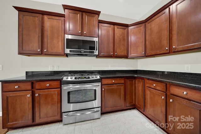 kitchen featuring dark stone counters and stainless steel appliances