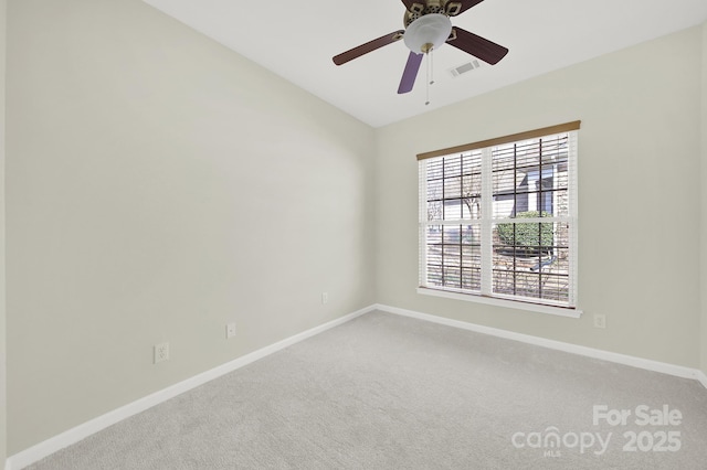 empty room with visible vents, baseboards, a ceiling fan, and carpet flooring