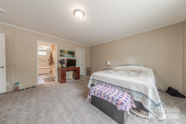 carpeted bedroom featuring a textured ceiling, ensuite bathroom, and ornamental molding