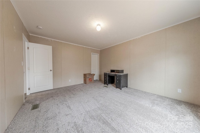 empty room with visible vents and carpet floors