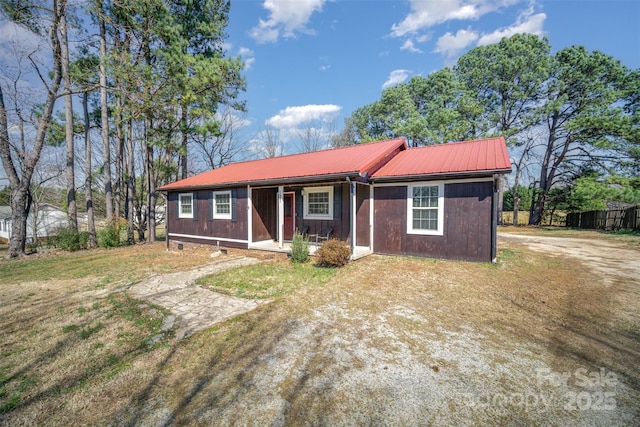 single story home with crawl space, covered porch, and metal roof