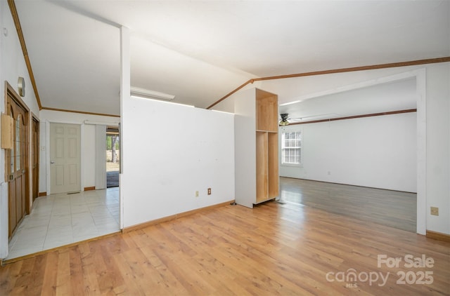 unfurnished room with vaulted ceiling, a ceiling fan, light wood-style flooring, and crown molding