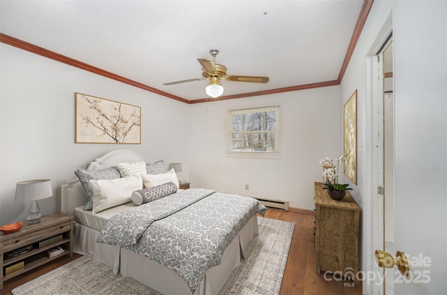 bedroom with ceiling fan, a baseboard radiator, wood finished floors, and crown molding