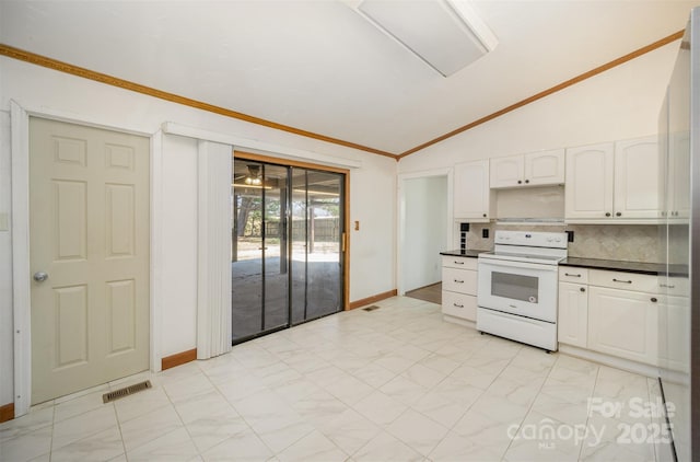 kitchen featuring lofted ceiling, electric stove, dark countertops, and white cabinets