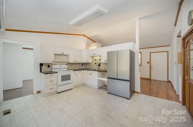 kitchen featuring electric range, visible vents, white cabinetry, freestanding refrigerator, and dark countertops