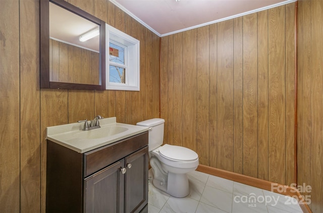 bathroom with wooden walls, vanity, and toilet