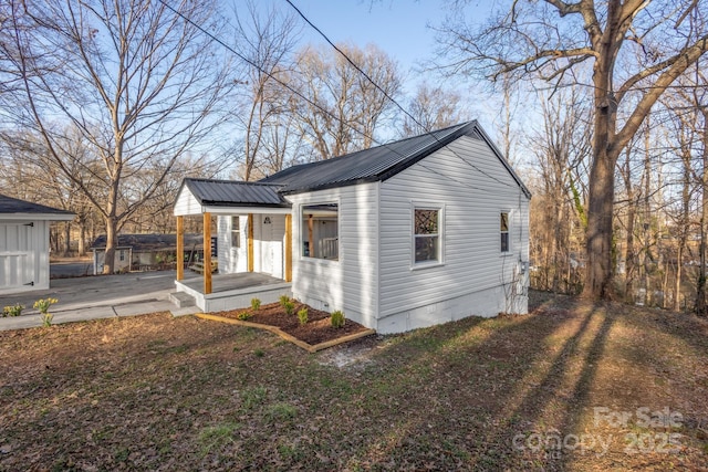 exterior space with metal roof and a porch