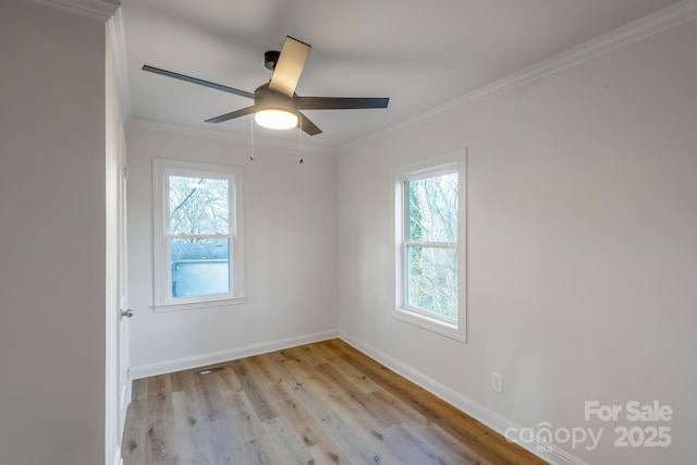 empty room featuring ceiling fan, light wood-style flooring, visible vents, baseboards, and crown molding