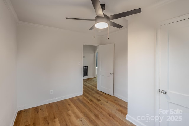 unfurnished bedroom with a ceiling fan, visible vents, baseboards, ornamental molding, and light wood finished floors