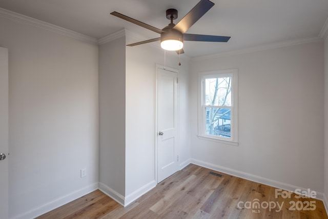 interior space with baseboards, light wood-type flooring, and crown molding