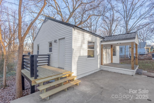 exterior space with a patio area and metal roof