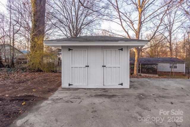 view of shed with fence