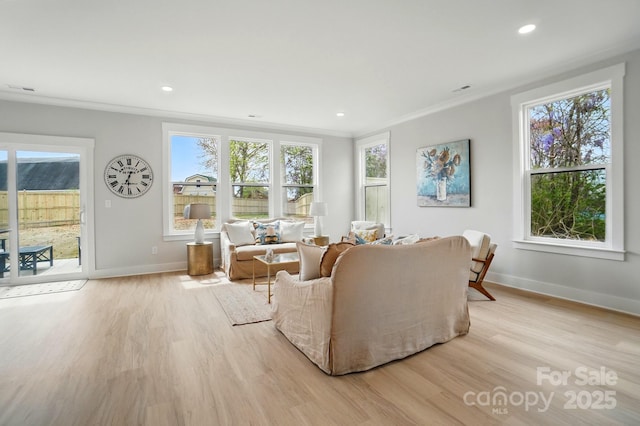 living area featuring recessed lighting, baseboards, ornamental molding, and light wood-style floors