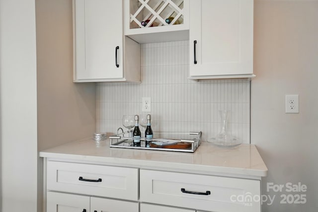 kitchen featuring light countertops, white cabinetry, decorative backsplash, and black electric cooktop